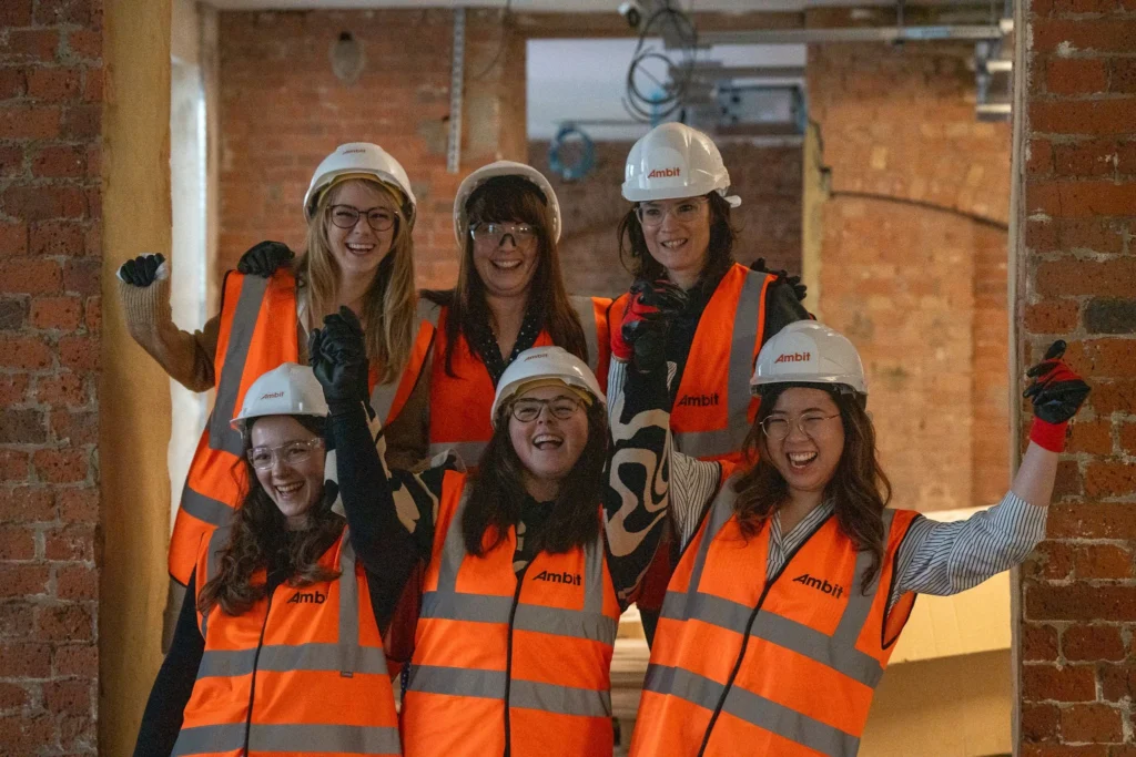 Careers Page featuring 6 women in Ambit PPE Kit smiling and cheering