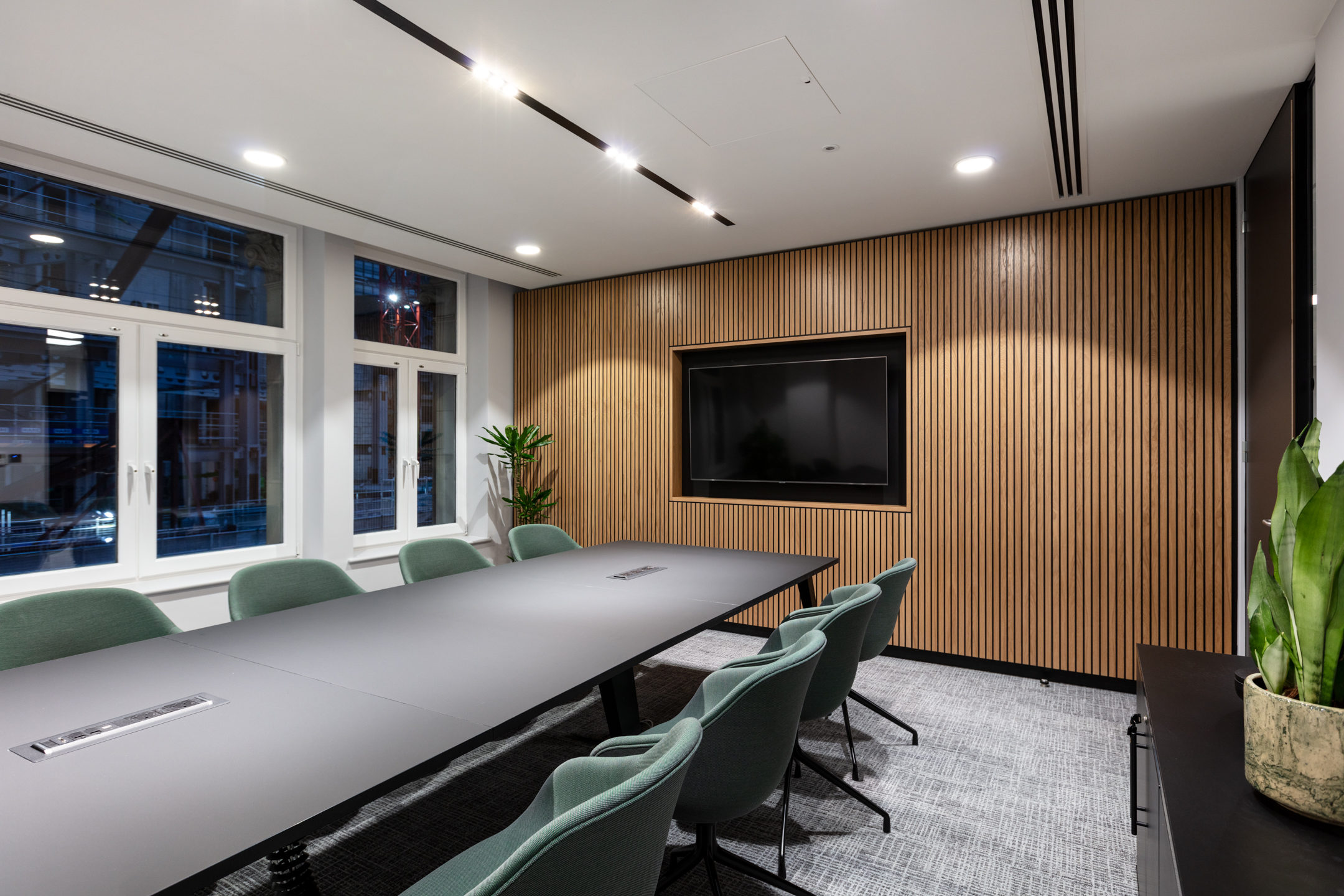 7 Bishops Gate, Level 3 meeting room with acoustic walls, a large meeting table and green chairs.