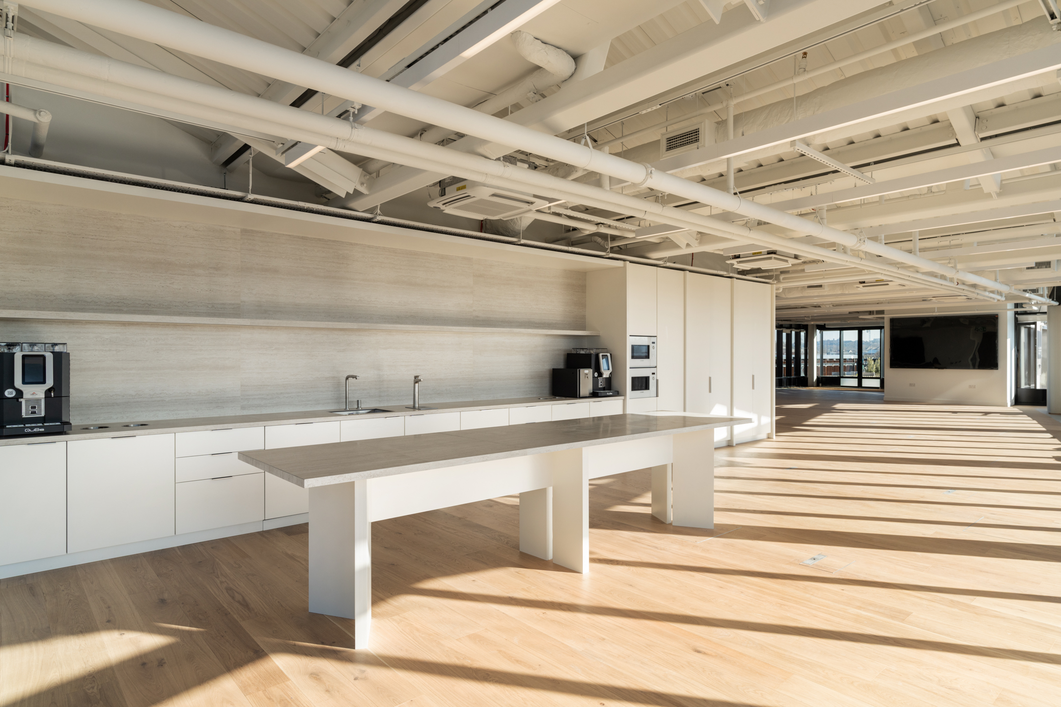 AMBIT LabTech open teapoint with an exposed white ceiling, kitchen essentials and a large screen.