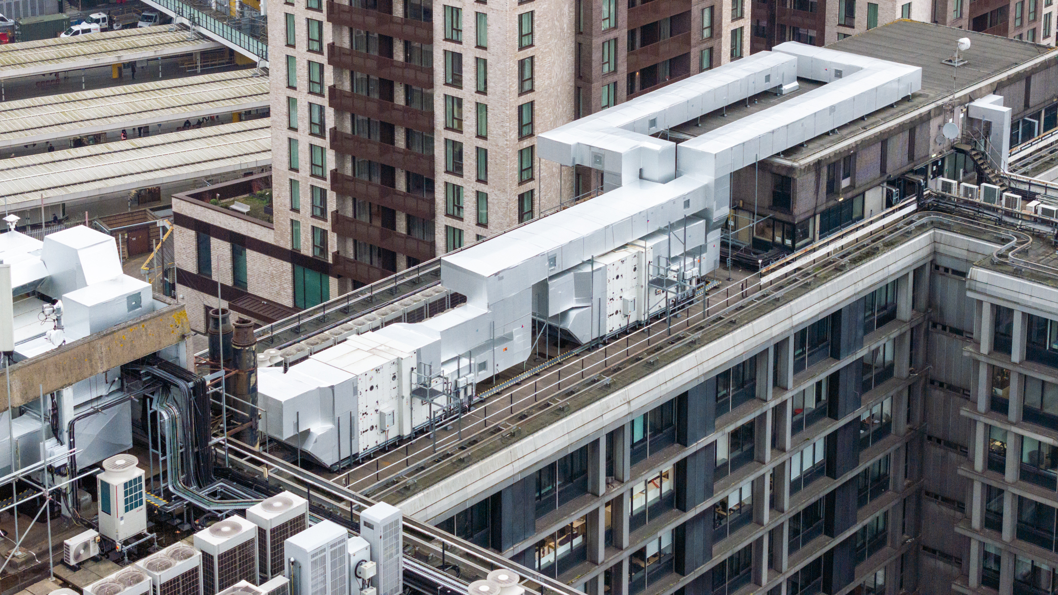 An aerial shot capturing the complex MEP refurbishment at Mosaic East, including upgraded HVAC systems and electrical infrastructure.