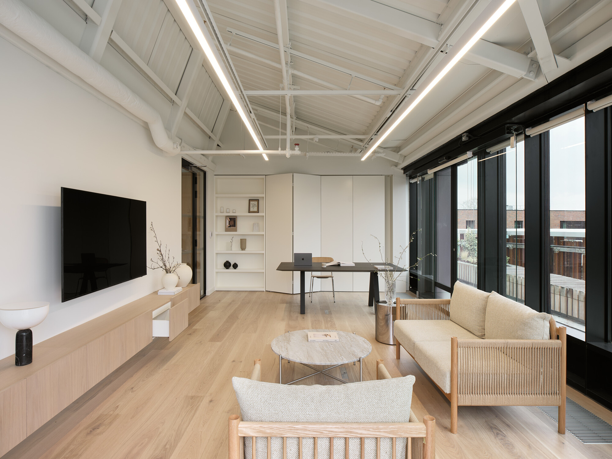 Office at Hawley Wharf, for Labtech with minimalist furniture, natural light, and exposed ceiling details.