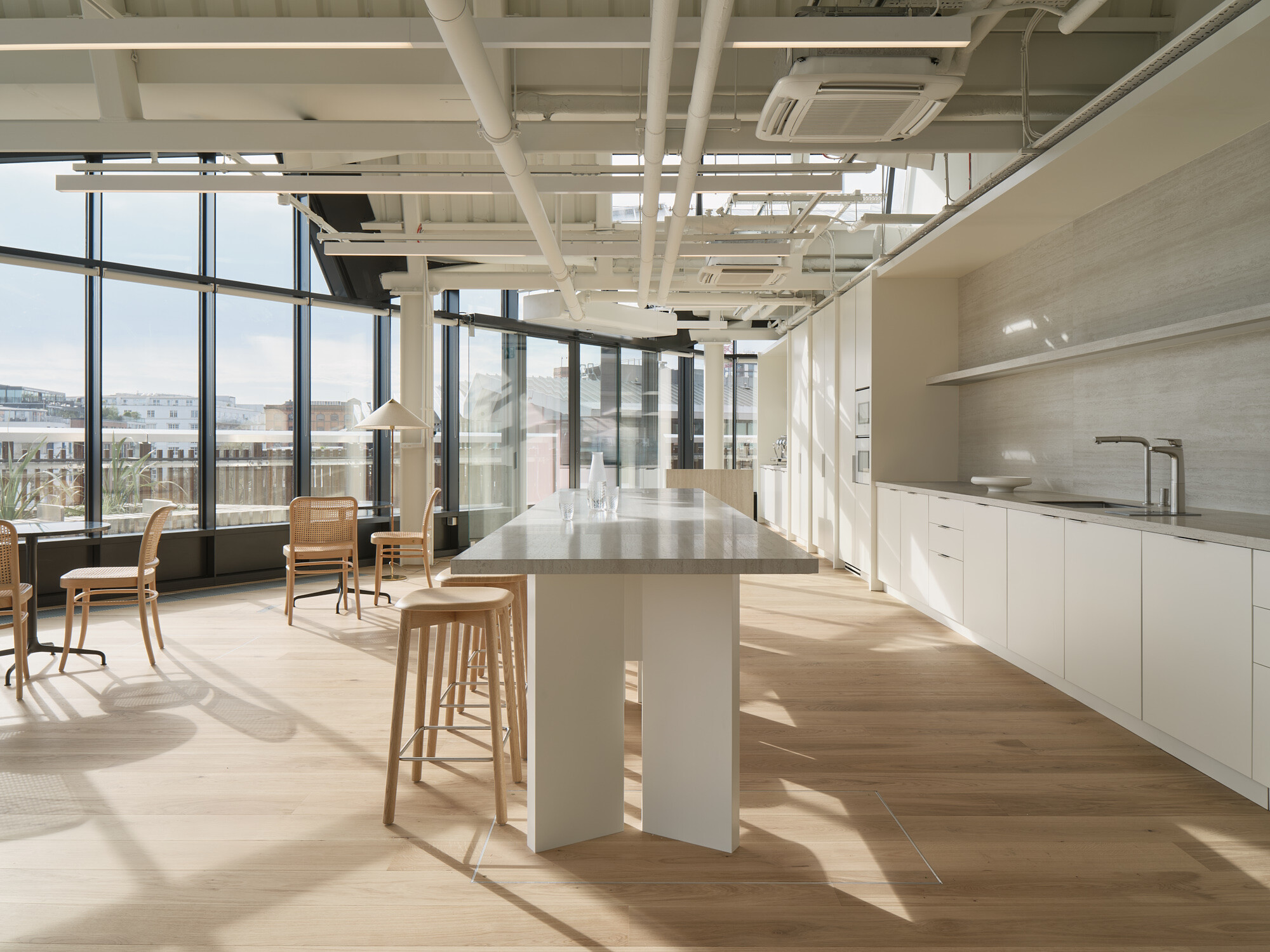 Bright teapoint and breakout space at Labtech’s Hawley Wharf, with floor-to-ceiling windows, light wood finishes and open ceiling services.