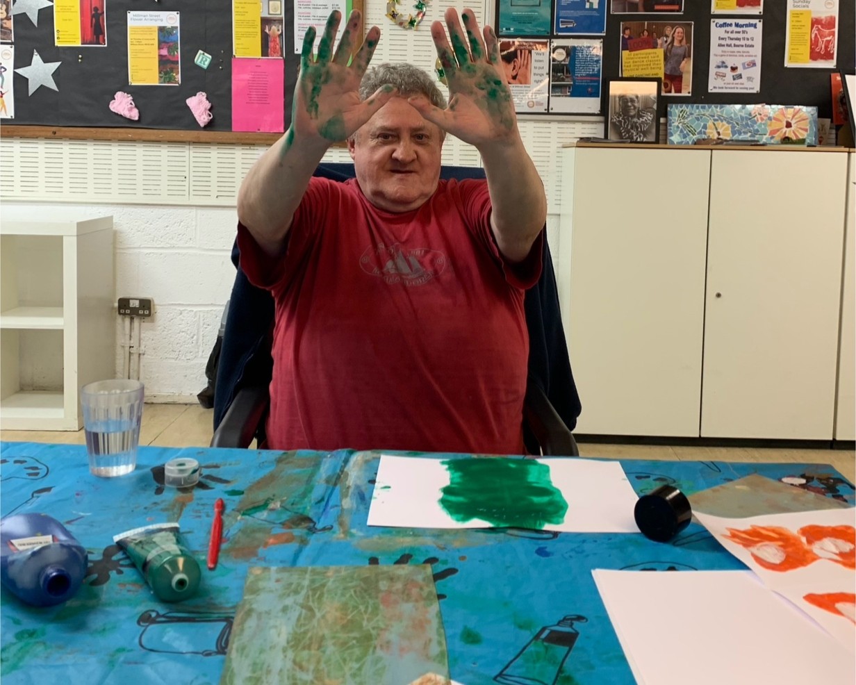 holborn community association sunday session, man showing his paint covered hands